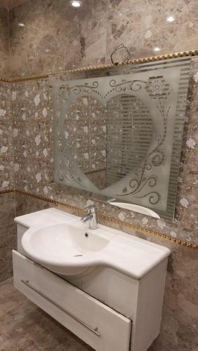 a bathroom with a sink and a mirror at شقه فندقيه المهندسين in Cairo
