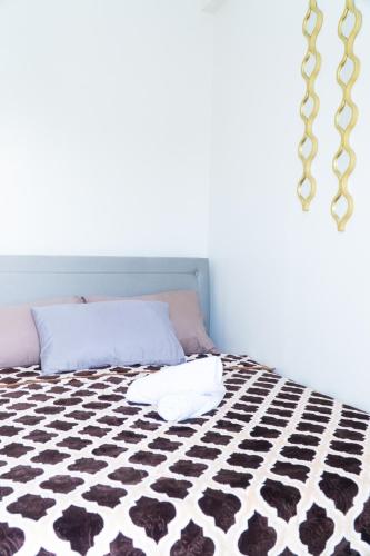 a bedroom with a bed with a black and white floor at Condotel Northpoint 2 Bedroom 1 bathroom in Davao City