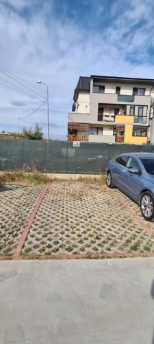a car parked in a parking lot in front of a building at Siriului Studio in Bucharest