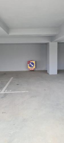 an empty parking garage with a sign on the wall at Marble Studio in Bucharest