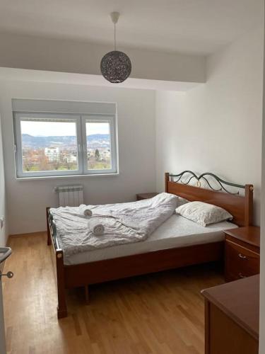 Apartment in Skopje في إسكوبية: غرفة نوم فيها سرير ونافذة