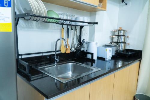 a kitchen counter with a stainless steel sink at Condotel Northpoint 2 Bedroom 1 bathroom in Davao City