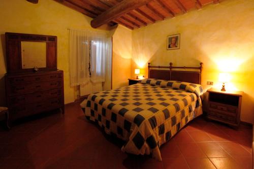 a bedroom with a bed and a dresser and a mirror at Agriturismo San Lorenzo in Lastra a Signa