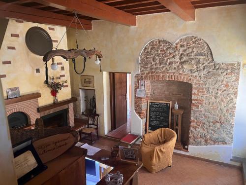 a living room with a large stone fireplace at Agriturismo San Lorenzo in Lastra a Signa