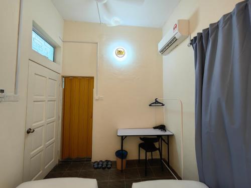 a bathroom with a table and a door and a desk at WW Hostel 22A Private Shower in George Town
