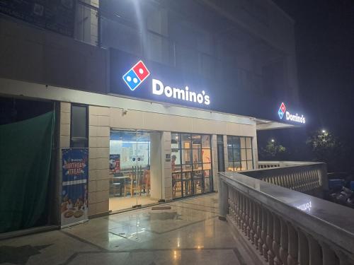 a donuts shop with a sign on top of it at Gokul 2 BHK Entire Flat, Bharat City, Teela Mod, Nr Hindon Airport ,Bhopura , Ghaziabad in Ghaziabad