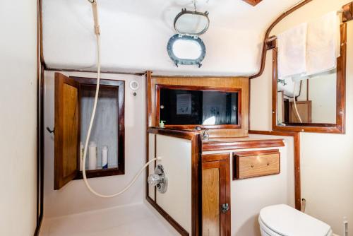 a bathroom with a toilet and a sink at Walk barefoot to beach! Two bathrooms! Entire private sailboat in Isla Mujeres