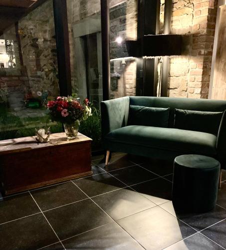 a living room with a couch and a table at B&B La Bouliniere in Malmedy