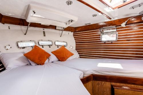 a bed in the back of a boat at Walk barefoot to beach! Two bathrooms! Entire private sailboat in Isla Mujeres
