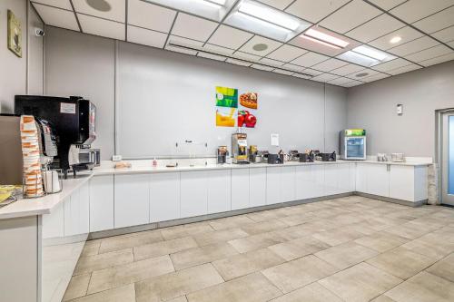 a large kitchen with white counters in a room at Quality Inn and Conference Center Tampa-Brandon in Tampa
