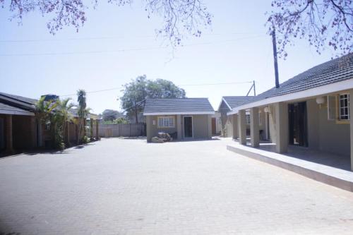 an empty driveway in front of a house at Palapye Guest House in Palatswe