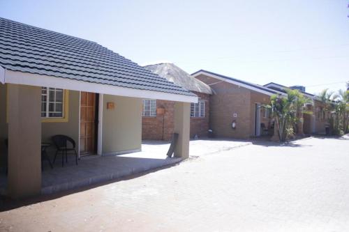 a group of buildings with a patio in front of them at Palapye Guest House in Palatswe
