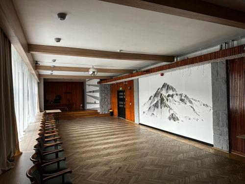 a room with a picture of a mountain on the wall at WRZOS resort & wellness **** DOMKI CAŁOROCZNE in Węgierska Górka