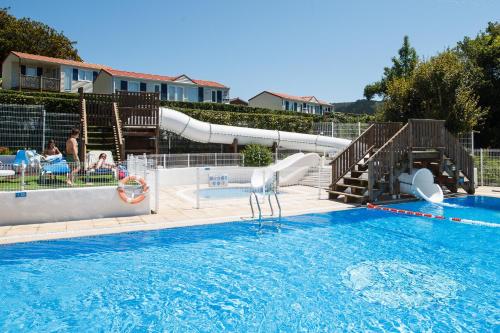 a swimming pool with a slide and a water park at Bungalows Portuondo parking gratuito in Mundaka
