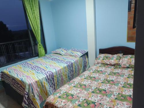 Ένα ή περισσότερα κρεβάτια σε δωμάτιο στο ApartaHotel El Balcón del Tolima