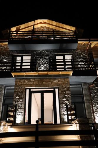 a building with a window and stairs on it at Sofra Kolonjare in Ersekë