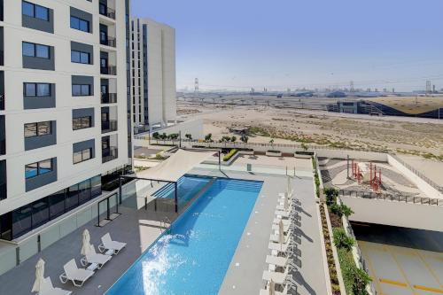 an overhead view of a hotel with a swimming pool and a beach at 3BDRM Near Metro for Family&Group in Dubai