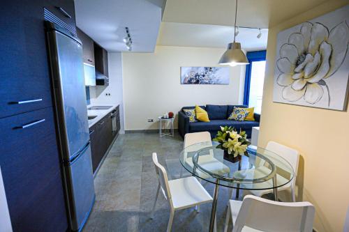 a kitchen and a living room with a glass table at Augusta Litoral - ONLY FAMILIES in Cambrils