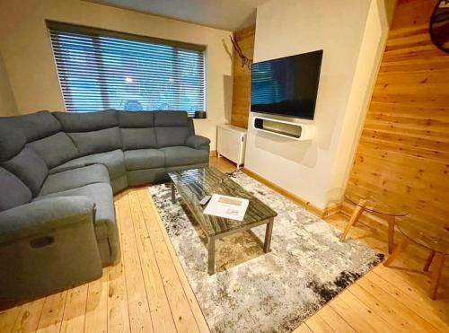 a living room with a couch and a coffee table at Entire house - Peaceful 3 bedroom home in Rishton