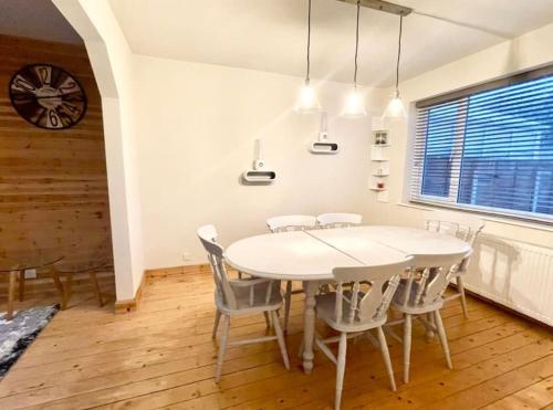 a dining room with a white table and chairs at Entire house - Peaceful 3 bedroom home in Rishton