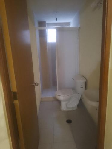 a bathroom with a toilet and a sink at Puerto mar 2 in Acapulco