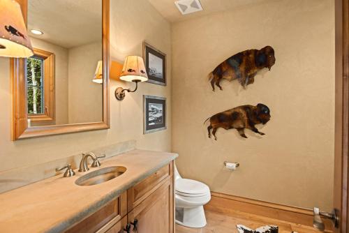 a bathroom with two pigs on the wall at Owl Creek 20, Luxury family home with private balcony, deck, hot tub, and patio - near lifts! in Snowmass Village