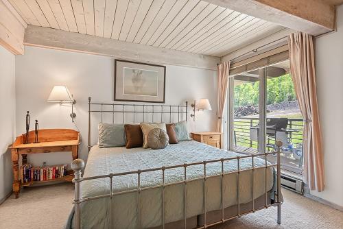 a bedroom with a bed and a balcony at Enclave 205, Snowmass Ski-In/Ski-Out Condo w/Shared Pool/Hot Tub/Gym/WiFi in Snowmass Village