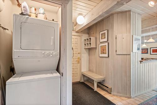 a kitchen with a refrigerator in a room at Enclave 205, Snowmass Ski-In/Ski-Out Condo w/Shared Pool/Hot Tub/Gym/WiFi in Snowmass Village