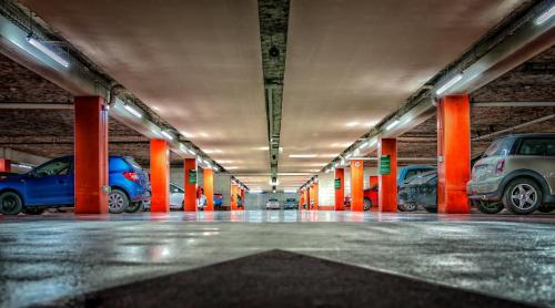 a parking garage filled with lots of parked cars at CAR PARKING AGRINIO SMART KEY BOX by PROJECT 86 IKE in Agrinion