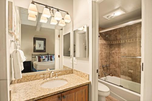 a bathroom with a sink and a toilet and a mirror at Enclave 305, Snowmass Ski-In/Ski-Out Condo w/Shared Pool/Hot Tub in Snowmass Village