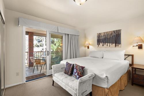 a bedroom with a large bed and a chair at Silverglo Condominiums Unit 308, Expansive 4 BD Condo, Walking Distance to Town with Pool Access in Aspen