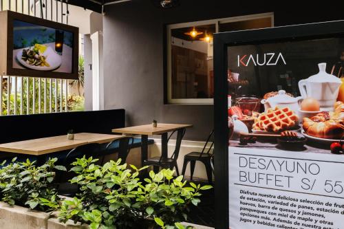 a sign in front of a restaurant with tables at TARATA BOUTIQUE HOTEL in Lima