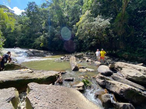 a group of people standing on rocks in a river at POSADA DEL CAMINO REAL in Moniquirá