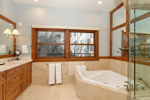 a bathroom with a tub and a glass shower at Durant Unit D5, Luxury Condo with Beautiful Furnishings, Great Views, and Central A/C in Aspen