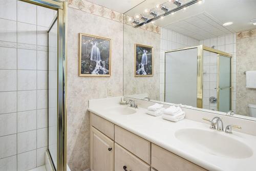 a bathroom with two sinks and a mirror at Fasching Haus Unit 8, Deluxe Condo w/ A/C, Private Deck, 2 Blocks to Downtown in Aspen