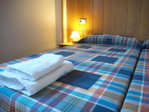 Un pat sau paturi într-o cameră la Posada de Ollo