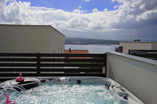a hot tub on the roof of a balcony at Sobol Apartments 'Navis' with private jacuzzi in Crikvenica