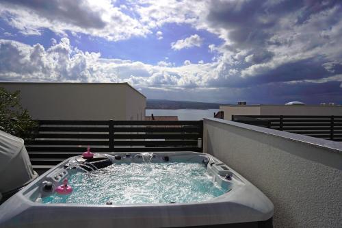 a hot tub on top of a balcony at Sobol Apartments 'Navis' with private jacuzzi in Crikvenica