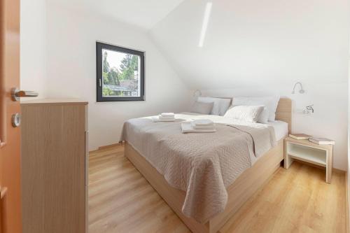 Postel nebo postele na pokoji v ubytování Apartments Nikolaj