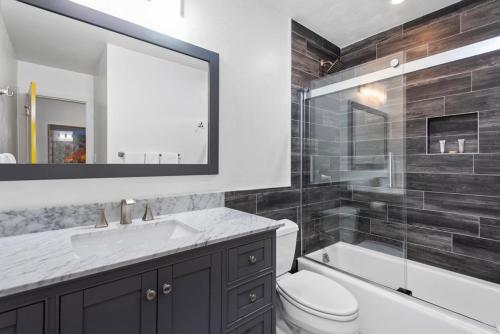 a bathroom with a sink and a toilet and a tub at Alpenblick 1, Three Level Townhouse with Fireplace, Private Balcony, and Great Location in Aspen