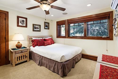a bedroom with a bed and a ceiling fan at Fasching Haus Unit 5, Deluxe Condo with Great Natural Light & Amazing Location in Aspen