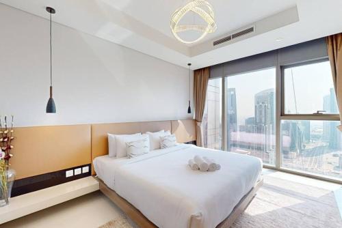 a bedroom with a large bed and a large window at Paramount, Midtown - Locations in Dubai