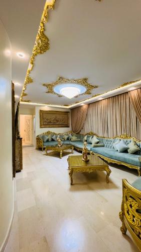 a large living room with couches and a table at Maison Fathallah in Mahdia