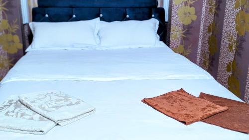 a white bed with white sheets and pillows on it at Apartments in the center in Taraz