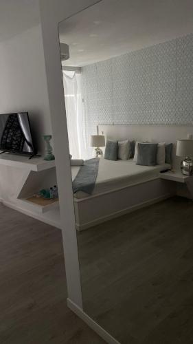 a bedroom with a large bed with a window at Brandão House in Caparica