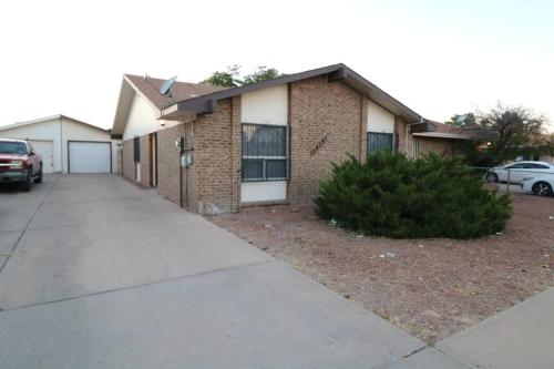 a brick house with a car parked in front of it at Two king, Cozy & Comfy! in El Paso