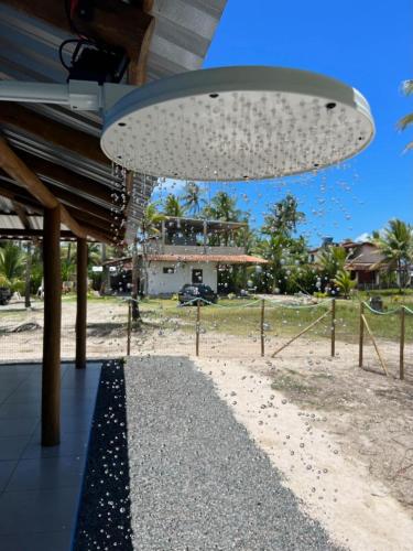 a large light hanging from a building next to a beach at Pousada Sete Estrelas do Mar in Ilhéus