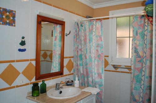 a bathroom with a sink and a shower curtain at Luxury Villa with Pool Sea and Mountain Views in Puerto de la Cruz in La Orotava