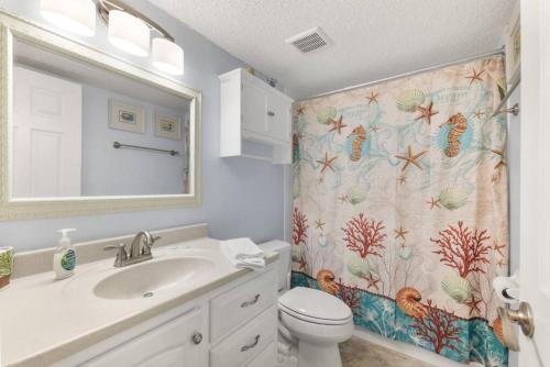 a bathroom with a sink and a shower curtain at Cozy Casita Beach Escape 850 A1A Unit 90 in St. Augustine