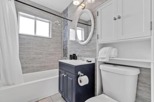 a bathroom with a toilet and a sink and a tub at Escape to Private Poolside Bliss in Hollywood